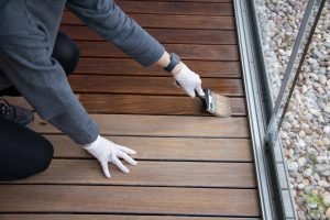 A professional performing wood floor refinishing in a Colorado home, restoring shine, durability, and beauty.